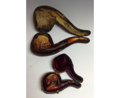 A 19th century Meerschaum pipe, the bowl boldly carved as a panorama of hounds and foxes in a feral forest, the scene held in