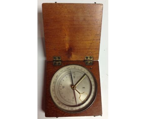 A 19th century/early 20th mahogany travelling pocket compass, silvered register, the needle with locking mechanism, hinged co
