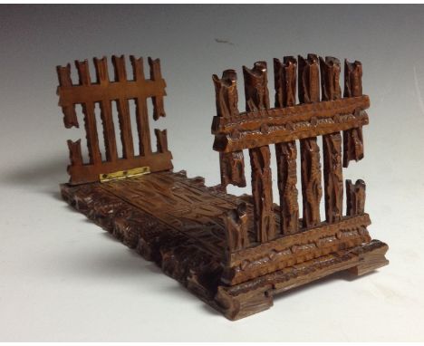 A Black Forest folding bookslide, the end supports carved as rustic gates, retailed by Stuffer & Binder, Baden-Baden, 29.5cm 
