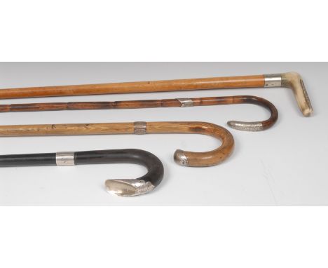 A silver mounted walking stick, bamboo shaft, 90cm long;  others (4)