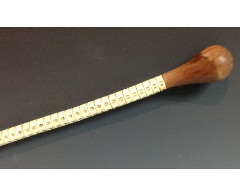 An early 20th century stingray vertebrae swagger stick, bulbous hardwood handle, 81.5cm long, c. 1940

Provenance: from Nairo