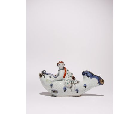A RARE JAPANESE ARITA VESSEL EDO PERIOD, C.1700-40 Modelled as a man riding on a giant carp, painted in underglaze blue, gilt