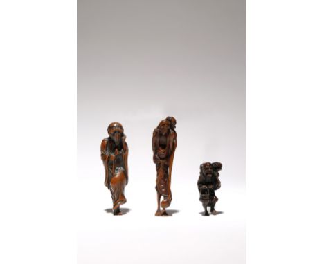 THREE JAPANESE WOOD NETSUKE OF FIGURES EDO AND MEIJI PERIODS, 18TH AND 19TH CENTURIES The tallest carved as Ashinaga carrying