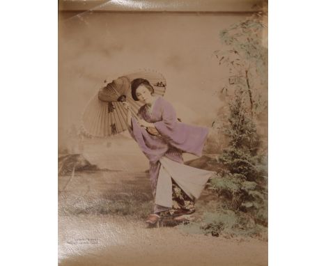 KUSAKABE KIMBEI (1841-1934) MEIJI PERIOD, 19TH CENTURY A Japanese hand-coloured albumen print depicting a young beauty holdin