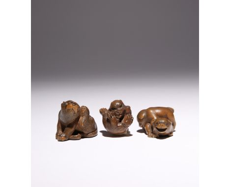 THREE JAPANESE WOOD NETSUKE MEIJI PERIOD, 19TH CENTURY The first carved as a tiger scratching its ear, its pupils inlaid and 
