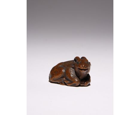 A JAPANESE WOOD NETSUKE OF A RAM EDO PERIOD, 19TH CENTURY Recumbent and with its head slightly turned to the right, its long 