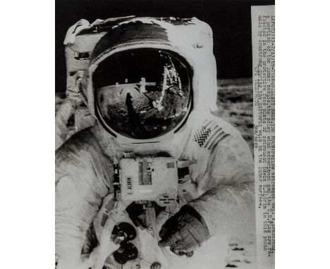 ** Apollo 11.- Armstrong (Neil)  An uncommon close-up view of Buzz Aldrin's gold-plated visor, reflecting the U.S. flag, the 