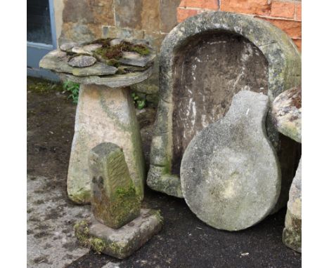  A large stone garden basin, together with a staddle stone base, another smaller, a square stone plinth and two other stone b