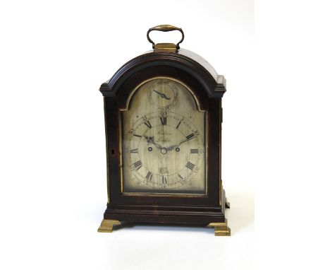 A George III ebonised and brass mounted table clock by John Holmes, London, late 18th century, the arched top with a heavy br