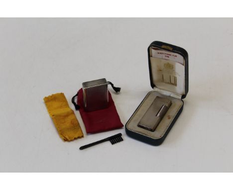 A cased silver plated Dunhill Rollagas lighter, together with another by Dupont. Both with engine turned decoration