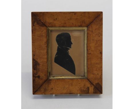 19th century English School, a silhouette portrait miniature of a gentleman in formal attire. Cut card heightened with gilt, 