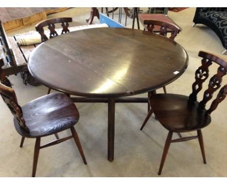 A dark wood Ercol drop leaf table & 4 old Colonial style chairs.