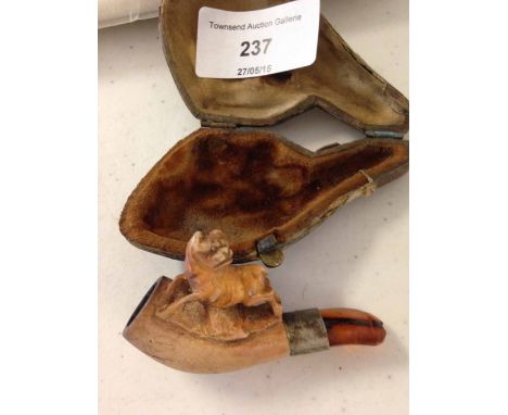 A small carved meerschaum pipe with dog on top of bowl, in original case.