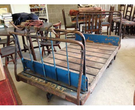 Vintage railway station porters flatbed luggage trolley.