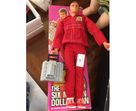 An original 1970s boxed Six Million Dollar Man action doll with engine block in working condition.