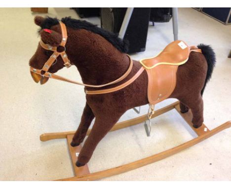 A childs brown plush rocking horse. Approx 79cm (31") tall to top of head and 60cm (24") floor to saddle. With 'neighing' sou