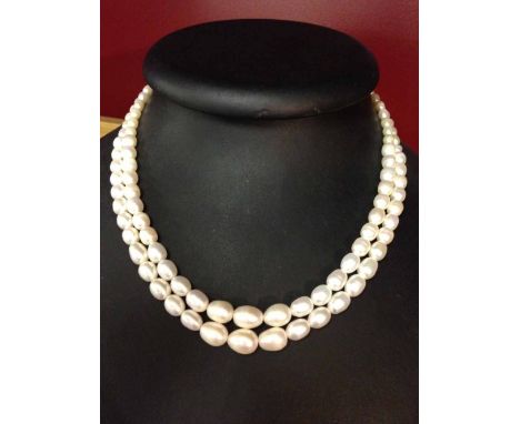 Double string freshwater pearl necklace, pearls of oval shape with graduated sizes.