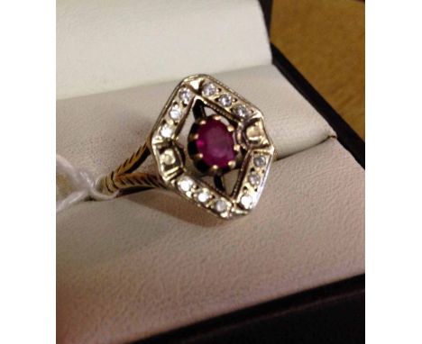 9ct gold ring set with oval ruby with a diamond shaped mount set with small white stones. Weight approx 3.4g size V