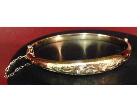 A 9ct rose gold ladies bangle, HM Birmingham 1920, with engraved design, approx 7g.
