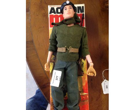An original 1960s boxed Action Man figure in original uniform with rifle. Gripping hands & flock hair.
