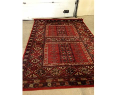 A large vintage red patterned wool carpet. Approx 290 x 200cm.