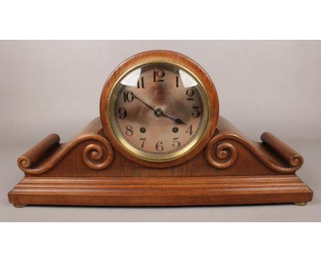 A Winterhalder &amp; Hofmeier carved oak 8 day mantel clock with scroll decoration.  