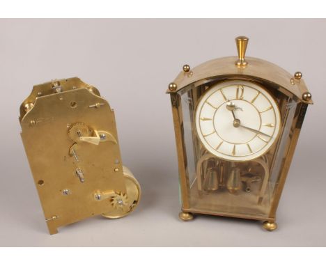 A Koma brass and glass torsion clock along with a clock movement.  