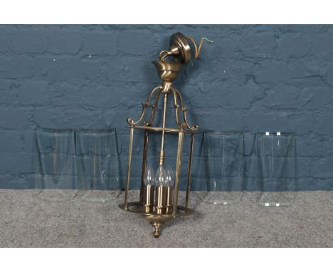 A brushed brass frame lantern - with four curved and bevelled glass panels. H: 63cm, W:25cm.  Condition good.