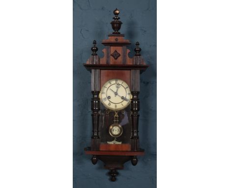 A mahogany cased wall clock. Chiming on a coiled gong. With pendulum and key.  Top pediment loose.