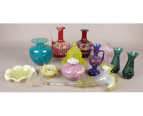 A quantity of coloured art glass. Including jugs, epergne flute, vases, etc.  Crack and repair to red jug. Blue twin handle v