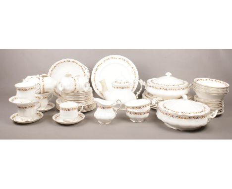 A collection of Royal Kent 'Golden Glory' bone chine tea &amp; dinnerware. Teapot, teacups/saucers, tureens, dinner plates, e