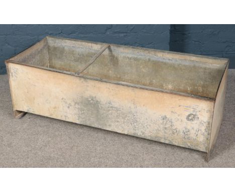 A large galvanised metal feeding trough. (40cm x 123cm x 51cm)  