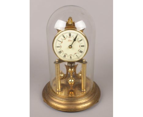 A German brass torsion clock with floral enamel dial.  