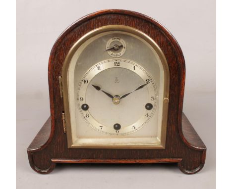 A Gustav Becker oak cased dome top mantel clock.  