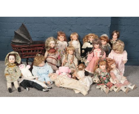 A collection of porcelain dolls, Danbury Mint, Alberon designs examples to include a vintage style dolls pram.( some have cer