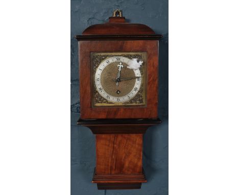 A small Bravington's mahogany cased wall clock with key. (40cm)  