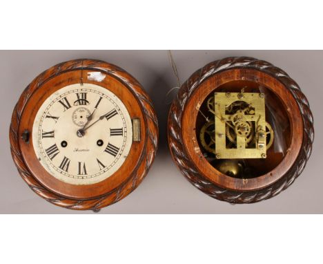 Two carved mahogany clocks by Ansonia clock company with rope twist borders.  One missing clock dial. Both without covers.