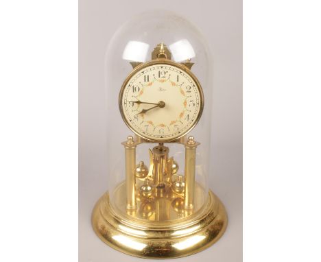 A Hess brass torsion clock under dome.  