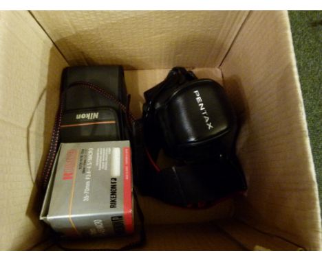 Pentax P30 film camera, Nikon camera and a SMC Pentax~A 1:2 50mm lens and one other.