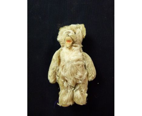 Vintage mohair Steiff? small open mouthed teddy bear lacking ear button. Moveable limbs and vertical stitched nose. H: 17cm