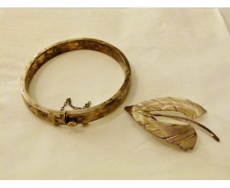 Hallmarked silver bangle and a sterling silver brooch.