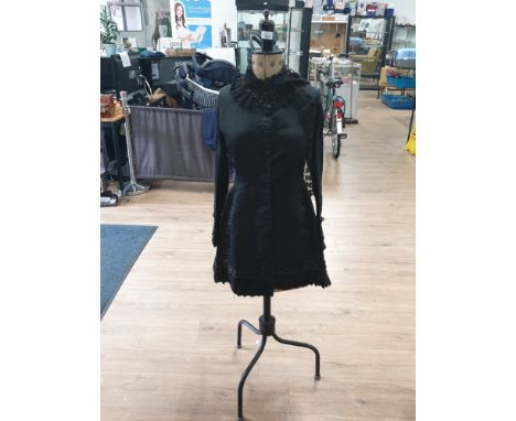A VICTORIAN LADIES CREPE MOURNING JACKET WITH FRENCH JET AND MACHINE MADE LACE TRIM ON A VINTAGE ADJUSTABLE DRESS MAKERS DUMM