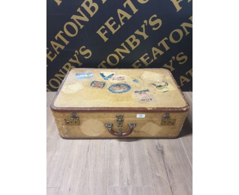 A VINTAGE TRAVELLING TRUNK WITH APPLIED WITH TRAVEL LABELS
