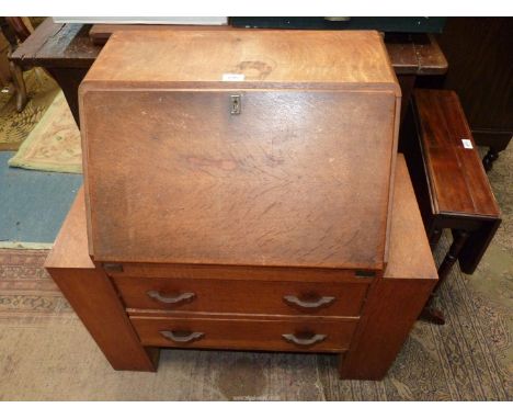A compact Art Deco design Oak Bureau, the fall front revealing an interior with five recesses and a drawer. The base with two