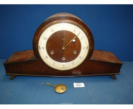 A Smiths Westminster chiming Mantle Clock in darkwood case and Arabic numerals, with pendulum and key.