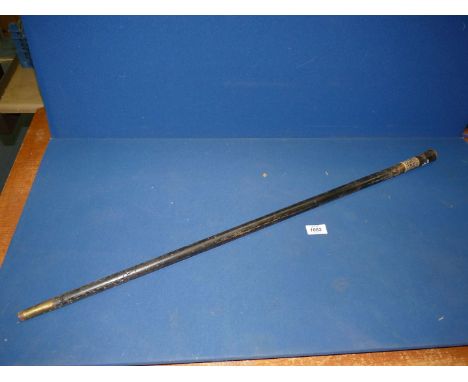 A Sword stick in ebonised wood sheath with inlaid detail to the handle and mask head to the end, the blade marked India.