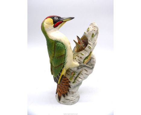 A limited edition figure of a Woodpecker feeding young in tree trunk, no. AP1/12 by Windmill Studio for H.P. Bulmer Limited, 