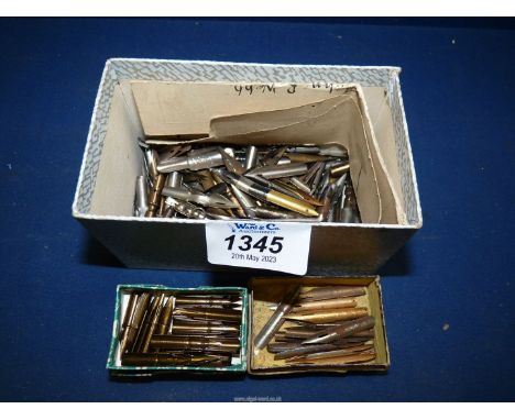 An assortment of vintage pen nibs, mostly unused.