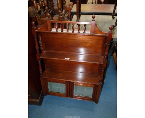 An Edwardian Mahogany wall hanging Shelf Unit having turned supports and spindles to the pediments, the base with a pair of o