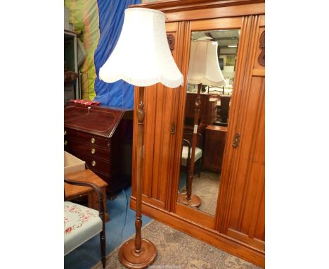 A turned and fluted column Standard Lamp having a nice quality fringed beige shade decorated in relief with stylised foliage,